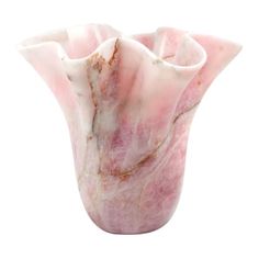 a pink marble vase sitting on top of a white table