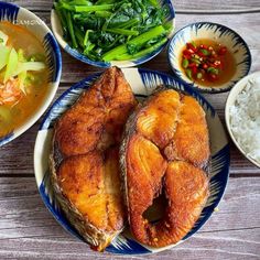 there are many different foods on the table together, including fish and rice with broccoli