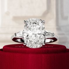 an oval diamond ring with baguets on top