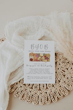 a close up of a doily on a table with a white cloth and some type of brochure