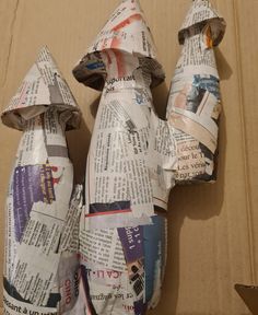 an origami cat made out of newspaper paper