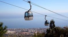 two gondola cars on the top of a mountain