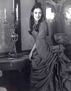 an old black and white photo of a woman in a dress