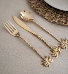 three forks and two spoons on a table