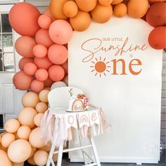 an orange and white birthday party with balloons