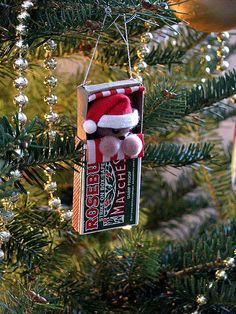 a christmas ornament hanging from a tree in the shape of santa clause hat