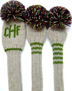 three knit mittens with colorful pom - poms on them