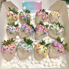 chocolate covered strawberries with sprinkles and frosting in a white box