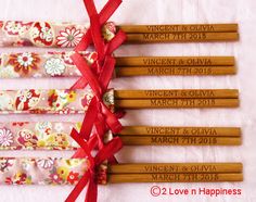 six wooden chopsticks with red ribbon tied around them