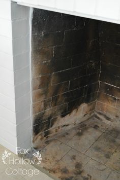 a fire place that has been cleaned and is in the process of being painted white