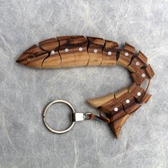 a wooden keychain with white dots on it