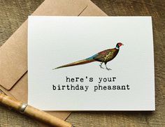 there's your birthday pheasant card on a table next to a pen