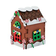 a gingerbread house is decorated with candy canes and candies on the roof