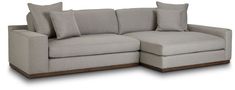 a couch with pillows on the back and two side ends facing each other, in front of a white background