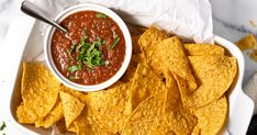 a white bowl filled with salsa and tortilla chips