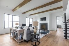 a living room filled with furniture and a fire place in the middle of a room