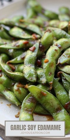 some green beans are on a white plate