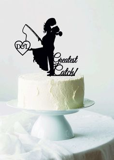 a cake topper with the words greatest catch and a silhouette of a woman holding a baseball bat