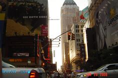 a busy city street filled with traffic and tall buildings