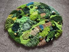 a round rug made out of various green plants