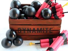 some black and red dynamites are in a wooden box