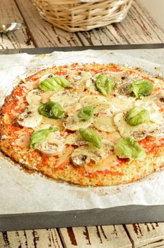 a pizza sitting on top of a pan covered in cheese and vegtables