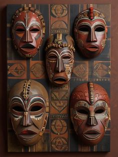 three wooden masks are hanging on the wall