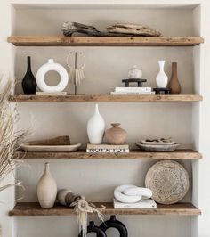 some shelves with vases and other items on them