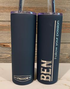 two blue tumblers sitting next to each other on a table