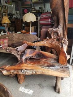 two pieces of wood sitting on top of a wooden bench in a room filled with furniture