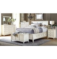 a white bed sitting in a bedroom next to a dresser