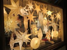 a window display with paper stars and lanterns