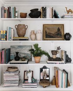 bookshelves with vases and other items on them