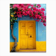 a yellow door with pink flowers on it and a tree in front of the door