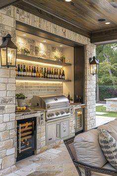 an outdoor kitchen with grill and seating area