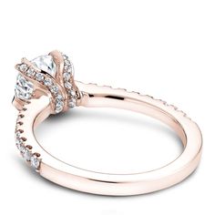 an 18k rose gold engagement ring set with two round diamonds on the band and side stones