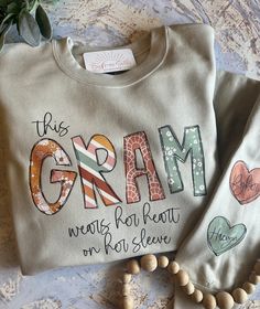 Sweatshirts For Grandma, This Grandma Wears Her Heart On Her Sleeve, Grandma Sweatshirt Ideas, Personalized Tops As Fall Gifts, Personalized Long Sleeve T-shirt, Grandma Tshirts Ideas, Grandma Shirt Ideas, Quilted Letters, Vinyl Sweatshirts