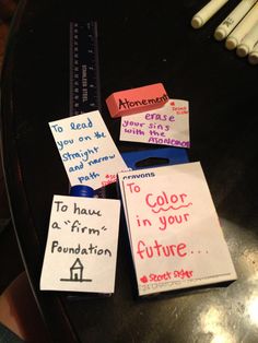 several pieces of paper that have been placed on a table with markers and pencils