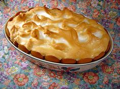 a pie sitting on top of a table covered in frosting