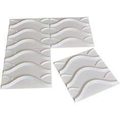 three pieces of white tile with wavy lines