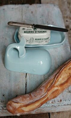 a loaf of bread sitting on top of a wooden table next to a knife holder