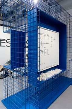 a blue caged room with a white board on the wall