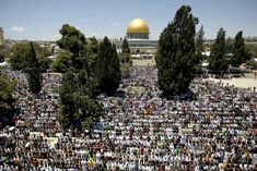 a large group of people gathered in front of the dome of the rock