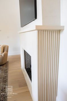 a flat screen tv mounted on the wall above a fireplace