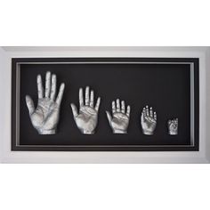 three handprints are displayed in a shadow box