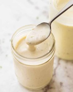 a spoon in a jar filled with cream