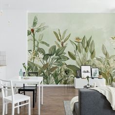 a living room filled with furniture and wallpaper covered in green leaves on the walls