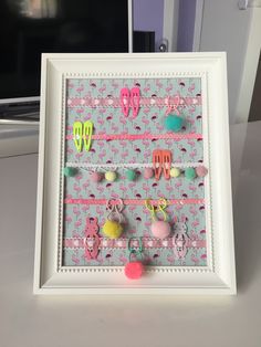 a white frame with some pink and green items on it