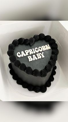 a heart shaped cake with the words capricon baby on it