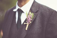 a man in a suit and tie with a boutonniere on his lapel